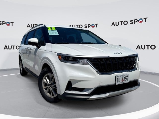 2023 Kia Carnival LX in White — front three-quarter view